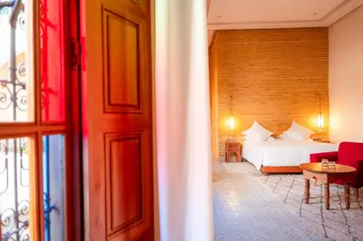 a hotel room with a bed and a table at Riad Al Ansari in Fès
