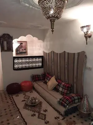 a living room with a couch and a chandelier at Dar Rihanne in Fès