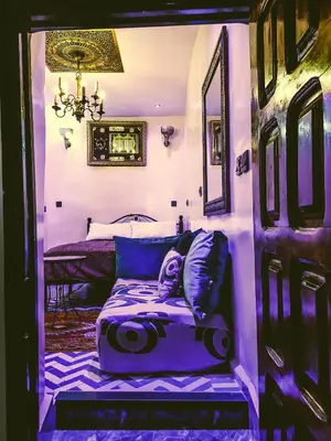a bed in a room with a purple room at Dar Rihanne in Fès