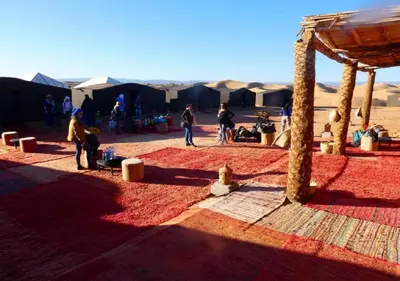a group of people standing around in the desert at Mhamid Luxury Camp Experience in Mhamid