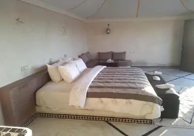 a bedroom with a large bed in a room at Mhamid Luxury Camp Experience in Mhamid