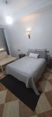 a bedroom with a large white bed in a room at Villa Fatima in Meknès
