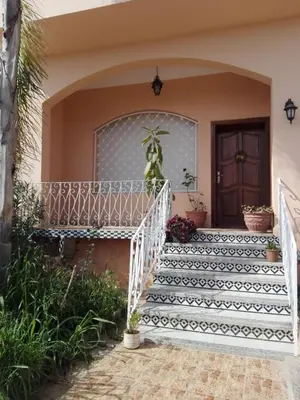 a staircase leading to a house with black and white tiles at Villa Fatima in Meknès