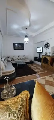 a living room with a couch and a tv at Villa Fatima in Meknès