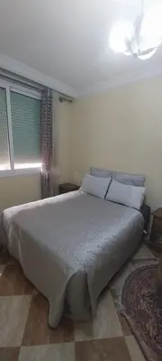 a bedroom with a large white bed in a room at Villa Fatima in Meknès