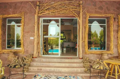 a room with two windows and a stairway with aitating at Diar illi in Touama