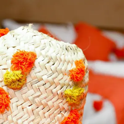 a wicker object with orange and yellow flowers on it at Luxury berber style in Merzouga