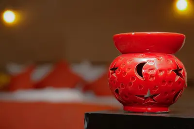 a red vase sitting on top of a table at Luxury berber style in Merzouga