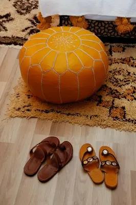 two pairs of sandals and a ball on a floor at Luxury berber style in Merzouga