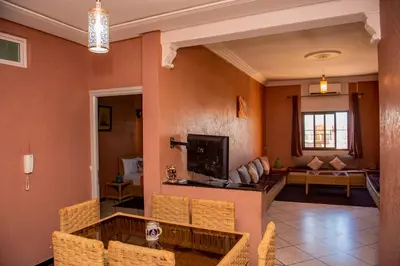 a living room with a table and chairs at Appartement Afgo Ouarzazate in Ouarzazate