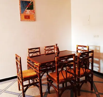 a dining room with a table and four chairs at Appartement Afgo Ouarzazate in Ouarzazate