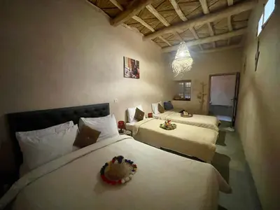 two beds in a room with two beds sidx sidx sidx at Maroc des Merveilles - Chez L'habitant in Kalaat MGouna