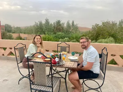a man and a woman sitting at a table at Maroc des Merveilles - Chez L'habitant in Kalaat MGouna