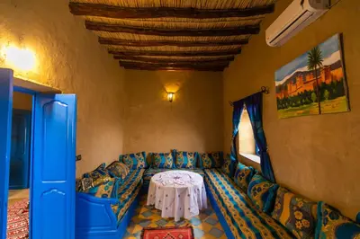 a living room with a couch and a table at Dar Duna in Hassilabied