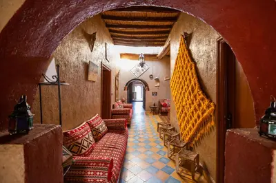 a hallway with couches and chairs in a building at Dar Duna in Hassilabied