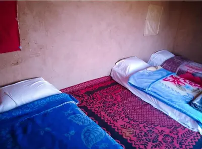 two beds sitting next to each other in a room at Camp Cheri Beri in Mhamid