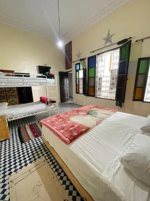 a bedroom with two bunk beds in a room at Dar Atlantic in Fès