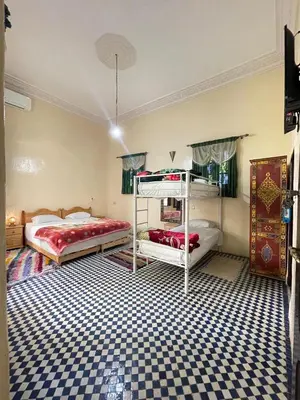 a bedroom with two bunk beds and a checkered floor at Dar Atlantic in Fès