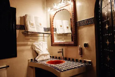 a bathroom with a sink and a mirror at OZ Palace Ouarzazate & SPA in Ouarzazate