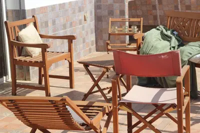 a group of chairs and tables on a patio at New Fez Apartments in Fès