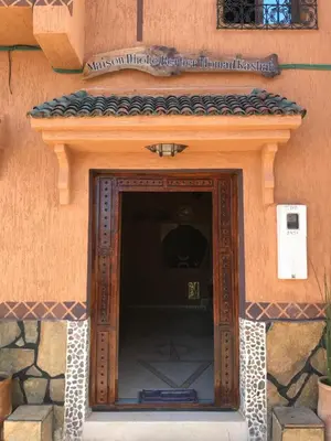 a wooden door in the side of a building at Berber Nomad Kasbah in Nkob