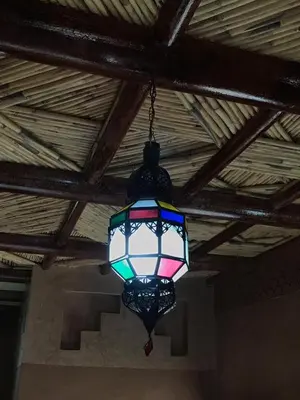 a light hanging from the ceiling of a room at Berber Nomad Kasbah in Nkob