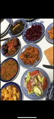 a table with many plates of food on it at Riad Fes Madaw in Fès