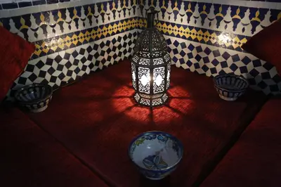 a lamp sitting on top of a table with some pots at Riad Le Sucrier de Fès in Fès