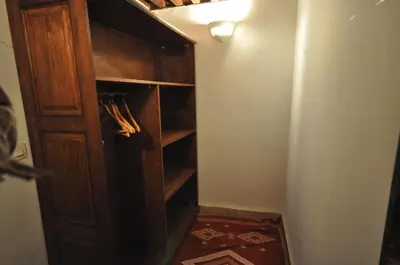a closet with a wooden door in a room at Riad Le Sucrier de Fès in Fès