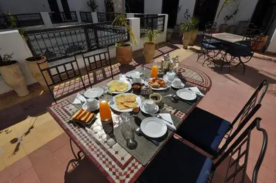 a table with breakfast food on top of a patio at Riad Le Sucrier de Fès in Fès