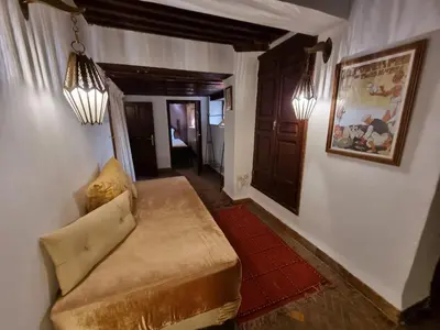 a living room with a couch in a room at Riad Le Sucrier de Fès in Fès