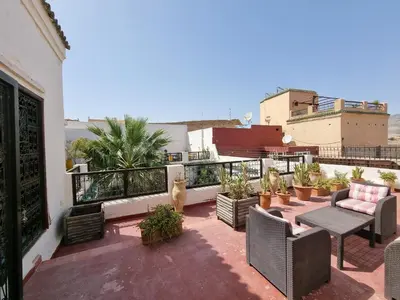a patio with chairs and a table on a balcony at Riad Le Sucrier de Fès in Fès