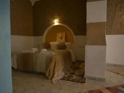 a bedroom with a large bed in a room at Casa Laman in Merzouga