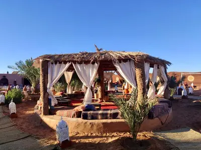 a gazebo with a bed in the desert at Desert Camp Laila in Mhamid