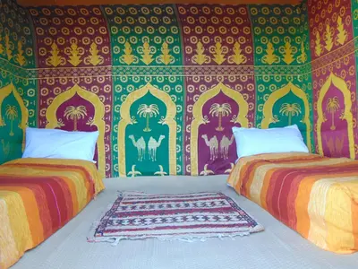 two beds sitting next to each other in a room at Merzouga Authentic Camps in Merzouga