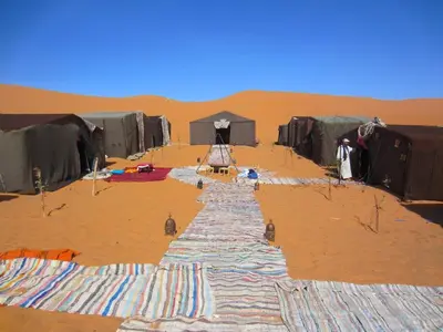 a group of tents in the desert at Merzouga Authentic Camps in Merzouga