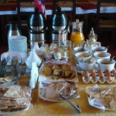 a table with food and eggs and other dishes at Sunset Camp Merzouga in Merzouga