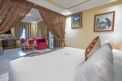 a bedroom with a large white bed in a room at Riad Sebti Fès in Fès