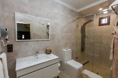 a bathroom with a toilet and a sink and a shower at Riad Sebti Fès in Fès