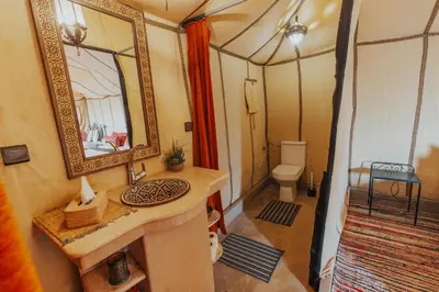 a bathroom with a sink and a mirror in a room at Royal Nomad Camp in Merzouga