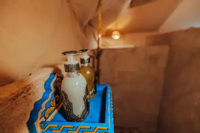 a table with two glass bottles on a blue tray at Royal Nomad Camp in Merzouga