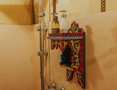 a shelf on a wall with two bottles on it at Royal Nomad Camp in Merzouga