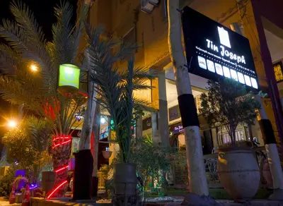 a sign in front of a store at night at Tin Joseph in Ouarzazate