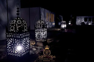 a couple of lights that are hanging in the dark at ITRAN ROYAL CAMP in Merzouga