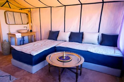 a room with a couch and a table in a tent at ITRAN ROYAL CAMP in Merzouga