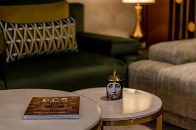 a living room with a coffee table with a book at Nour Plazza Hotel in Fès
