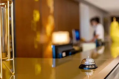 a glass table with a bell on top of it at Nour Plazza Hotel in Fès