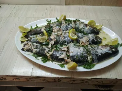 a plate of food on a wooden table at Maison d'hôtes Jnan Atlas in Sidi Abdalwahad