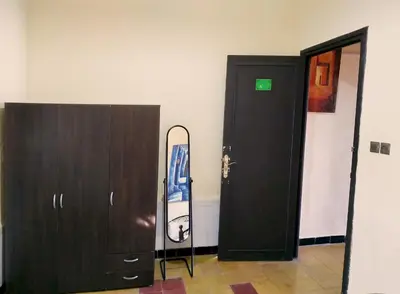 a room with a door and a snowboard leaning against a wall at Maison d'hôtes Jnan Atlas in Sidi Abdalwahad