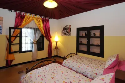a bedroom with a bed and a window at Maison d'hôtes Jnan Atlas in Sidi Abdalwahad